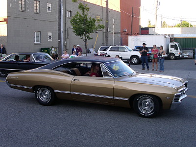 [A gold two-door car with a black roof.]